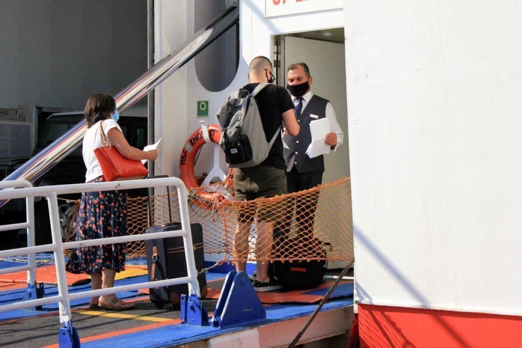 Greece, Piraeus, August 1 2020 - Passengers embarking on a ferry boat at the port of Piraeus, with Greek islands as destination.